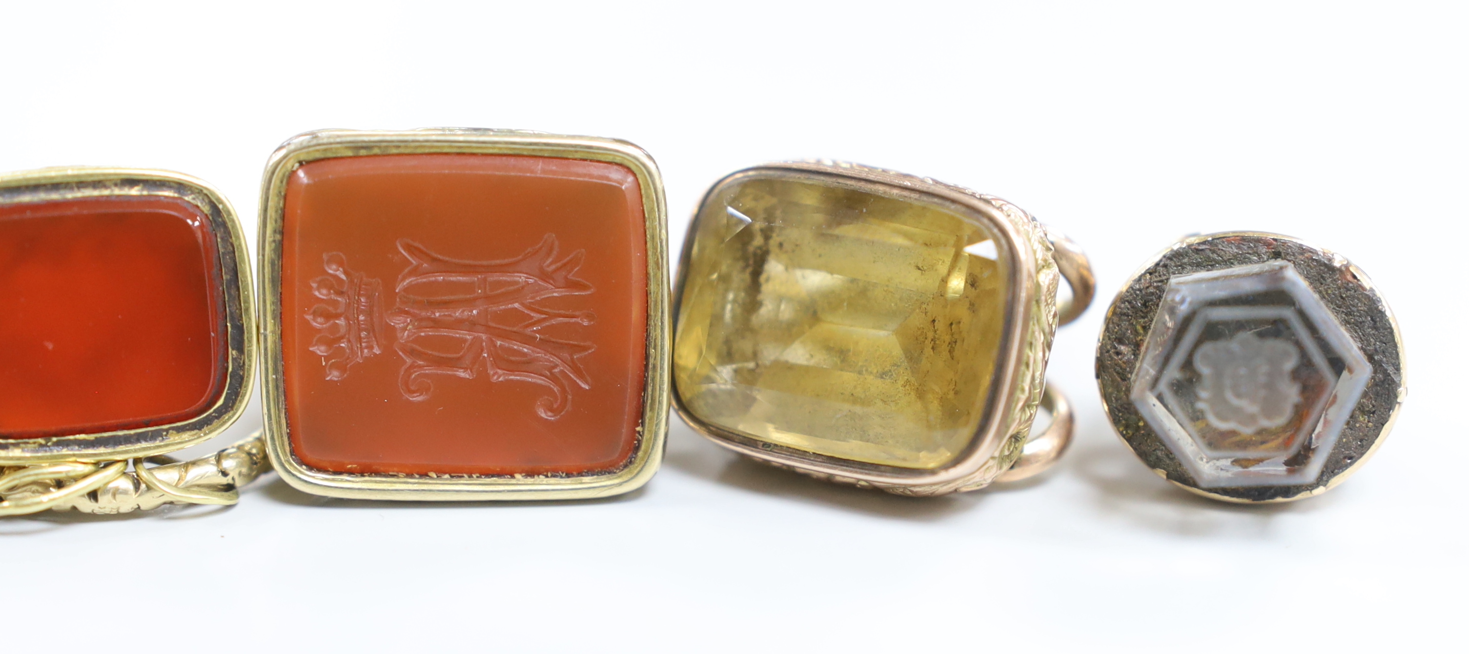 Six assorted 19th century yellow metal overlaid and carnelian or quartz set fob seals, largest 34mm, one matrix carved with armorial.